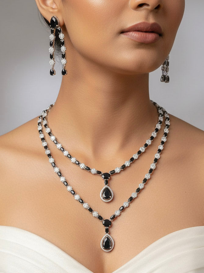 "A bride-to-be wearing an exquisite artificial diamond and black colored stone  necklace and matching earrings, designed for the perfect engagement look. This stunning artificial diamond jewelry set offers luxury and sophistication while being an affordable alternative to natural diamonds."
