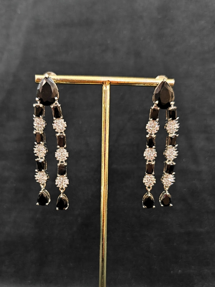 "Close-up of a woman wearing a sparkling artificial diamond and black colored stone Layered necklace and diamond earrings set, designed to offer a radiant, elegant look for any formal occasion or Indian wedding. This affordable diamond jewelry provides a flawless, luxurious alternative to natural diamonds."
