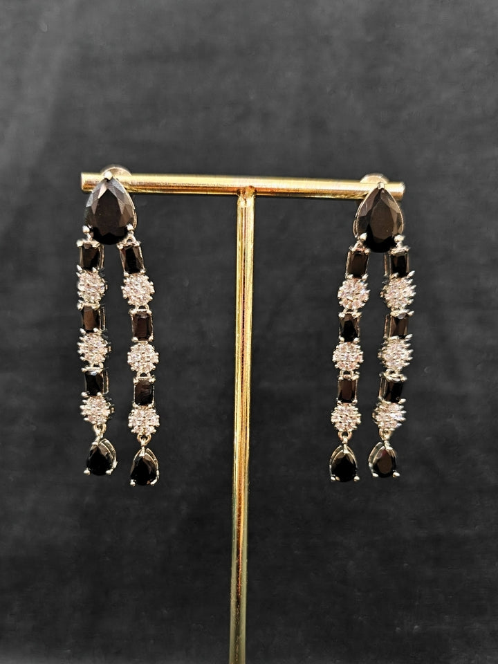"Close-up of a woman wearing a sparkling artificial diamond and black colored stone Layered necklace and diamond earrings set, designed to offer a radiant, elegant look for any formal occasion or Indian wedding. This affordable diamond jewelry provides a flawless, luxurious alternative to natural diamonds."
