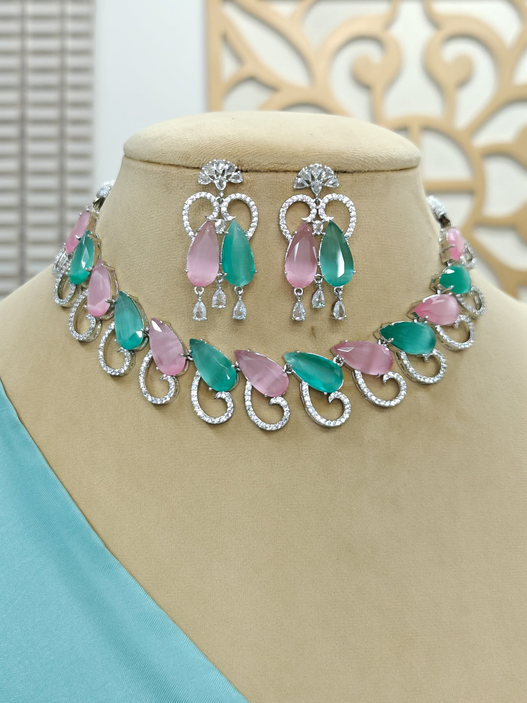 "Close-up of a model in luxurious artificial diamond jewelry featuring a designer diamond necklace with colored stone and earrings set, crafted for bridal fashion and high-end weddings. This beautiful diamond jewelry set offers the brilliance of real diamonds at an affordable price."
