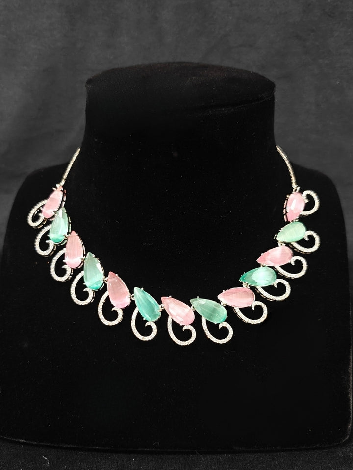 A beautiful artificial diamond necklace with colored stone and earrings set, ideal for festivals, family gatherings, and special celebrations in India. This elegant diamond jewelry provides the perfect blend of sparkle and tradition, with a modern twist.