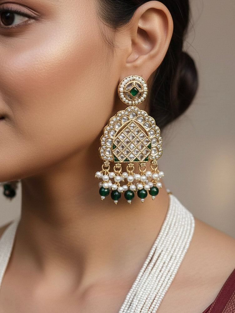 Close-up of a woman wearing an ornate traditional Green Rajwadi gold Long jewellery set and earrings with American Diamonds, Pearls, Crystal stones, Green colored stones. Woman styled in a royal Rajwadi artificial necklace set for a traditional Indian wedding. Reception party look featuring a statement Rajwadi necklace.