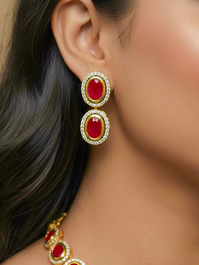 Close-up of a woman wearing an ornate traditional (Gold Polish) Pink Collar jewellery set and earrings with American Diamond and Pink Colored Stone. Festive Diwali outfit paired with a colorful Colored Stone necklace. Festive celebration look enhanced with traditional Colored Stone jewelry.