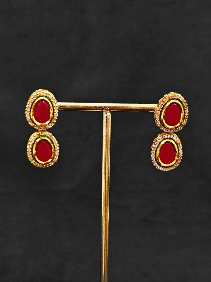 Close-up of an ornate traditional (Gold Polish) Pink Collar jewellery set and earrings with American Diamond and Pink Colored Stone. Festive Diwali outfit paired with a colorful Colored Stone necklace. Festive celebration look enhanced with traditional Colored Stone jewelry.