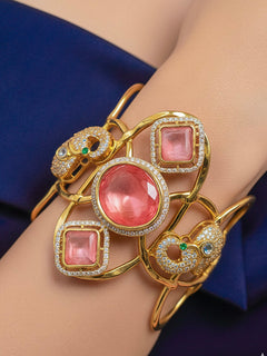 Close-up of a woman wearing an ornate Indo-western Mint Pink (gold Polish) Diamond Bracelet with Mint Pink Colored Stone and American Diamond. A woman wearing a luxury American diamond Bracelet styled beautifully for a wedding guest look in India. 