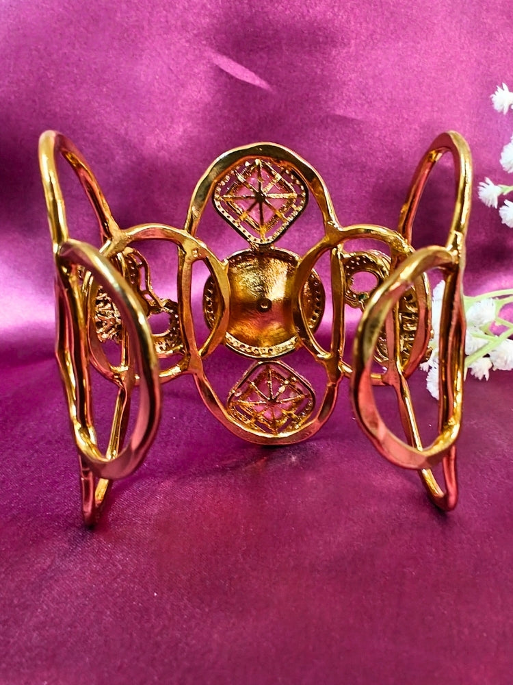 The Farah Mint Pink Bracelet (Adjustable) features intricate designs, three bold Mint Pink gemstones, and two elephant heads adorned with American diamonds —ideal for wedding ceremonies—shown on a purple fabric background.