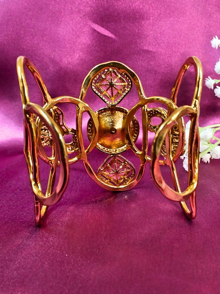 The Farah Mint Pink Bracelet (Adjustable) features intricate designs, three bold Mint Pink gemstones, and two elephant heads adorned with American diamonds —ideal for wedding ceremonies—shown on a purple fabric background.