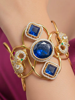 Close-up of a woman wearing an ornate Indo-western Mint Pink (gold Polish) Diamond Bracelet with Mint Pink Colored Stone and American Diamond. A woman wearing a luxury American diamond Bracelet styled beautifully for a wedding guest look in India. 
