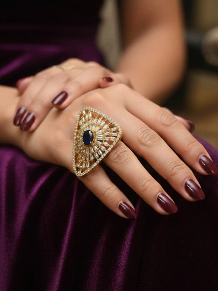 Close-up of a woman wearing an ornate Indo-Western Navy Blue Diamond Ring with American Diamond and Navy Blue Colored Stones. Close-up of an American diamond cocktail ring for party wear in India. Wedding guest wearing a statement artificial American Diamond cocktail ring.
