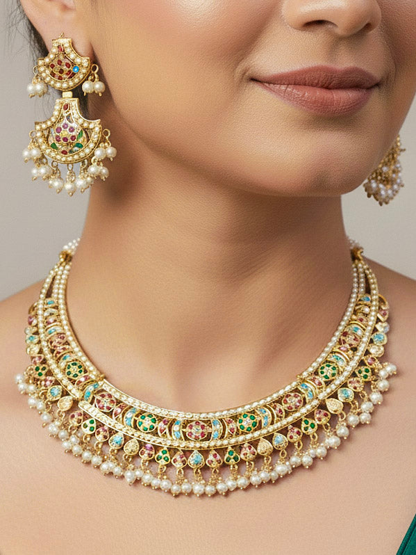 Close-up of a woman wearing an ornate traditional jadau gold jewellery set and jadau earrings with pearls and gemstones. Perfect Jadau necklace set for weddings and festivals. 