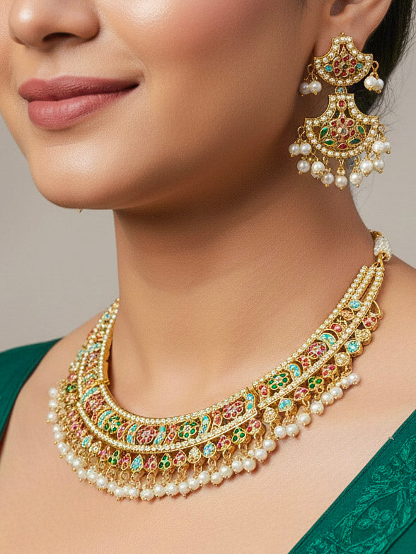 Close-up of a woman wearing an ornate handmade jadau jewelry set and earrings with multicolor jadau gemstones. This is a perfect jadau jewelry set for weddings, festivals and more. Can also be worn as bridal jadau jewelry for indian weddings. 