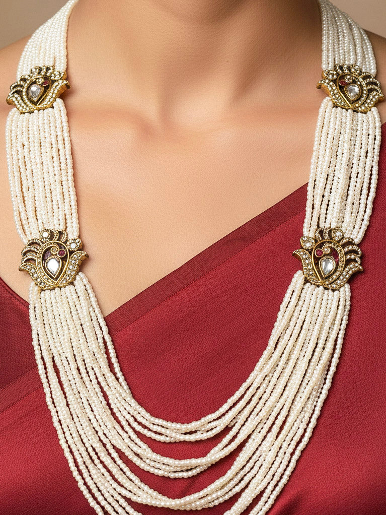 Close-up of a woman wearing an ornate traditional White Rajwadi gold Long Necklace with Pearls, American Diamond, Kundan. Festive Diwali outfit enhanced with a Rajwadi artificial necklace. Festive look completed with a luxury Rajwadi imitation necklace.