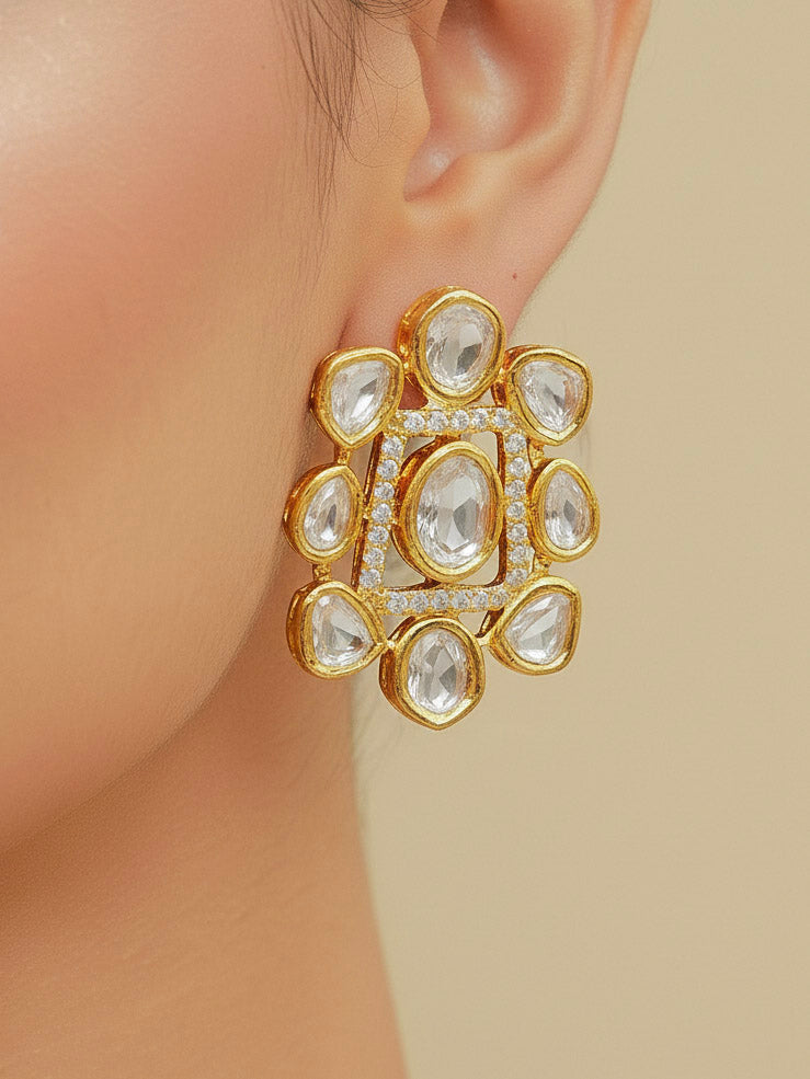 Close-up of a woman wearing an ornate Indo-western Layered Kundan (gold Polish) jewellery set and earrings with American Diamond and Kundan. Indo-western outfit styled with a lightweight Kundan necklace. Reception-ready look featuring elegant Kundan imitation jewelry.
