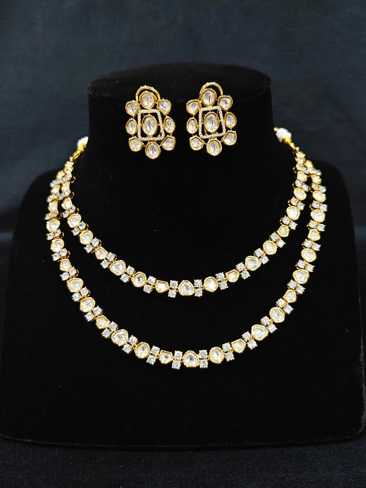 Close-up of an ornate Indo-western Layered Kundan (gold Polish) jewellery set and earrings with American Diamond and Kundan. Indo-western outfit styled with a lightweight Kundan necklace. Reception-ready look featuring elegant Kundan imitation jewelry.