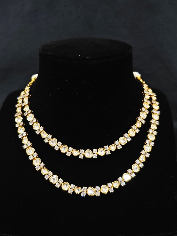 Close-up of an ornate Indo-western Layered Kundan (gold Polish) jewellery set and earrings with American Diamond and Kundan. Indo-western outfit styled with a lightweight Kundan necklace. Reception-ready look featuring elegant Kundan imitation jewelry.