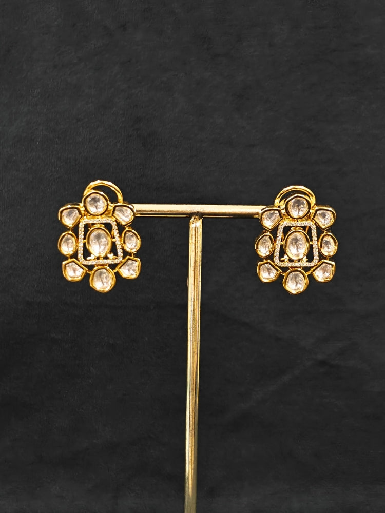 Close-up of an ornate Indo-western Layered Kundan (gold Polish) jewellery set and earrings with American Diamond and Kundan. Indo-western outfit styled with a lightweight Kundan necklace. Reception-ready look featuring elegant Kundan imitation jewelry.