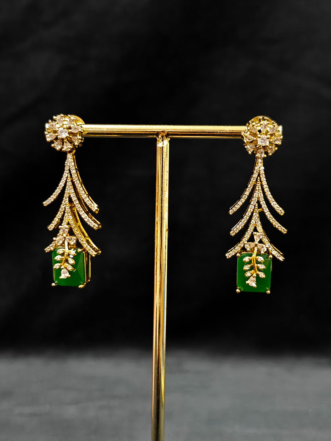 A glamorous artificial diamond and emerald green colored stone designer necklace paired with chic earrings, perfect for bridal wear. This high-quality artificial diamond jewelry set is the ideal choice for modern brides looking for a budget-friendly option with timeless sparkle."