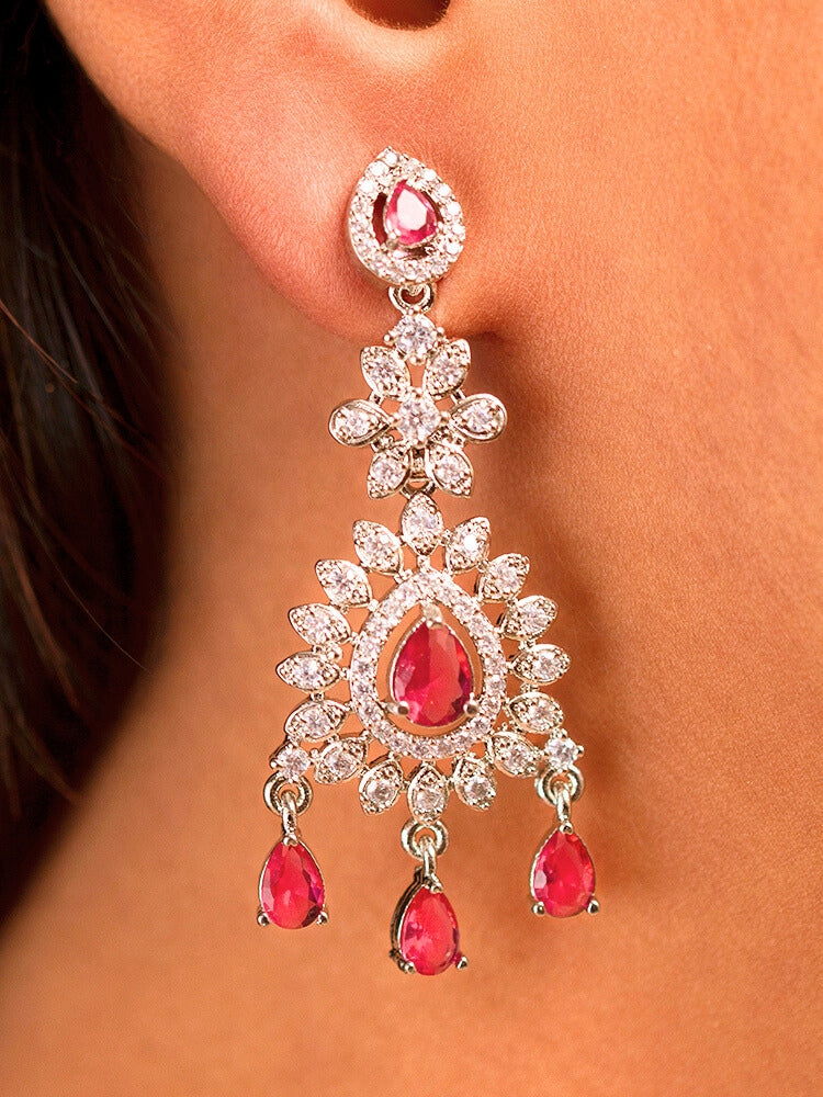 Close-up of a woman wearing a sparkling artificial diamond necklace with red colored stone and diamond earrings set, designed to offer a radiant, elegant look for any formal occasion or Indian wedding. This affordable diamond jewelry provides a flawless, luxurious alternative to natural diamonds.