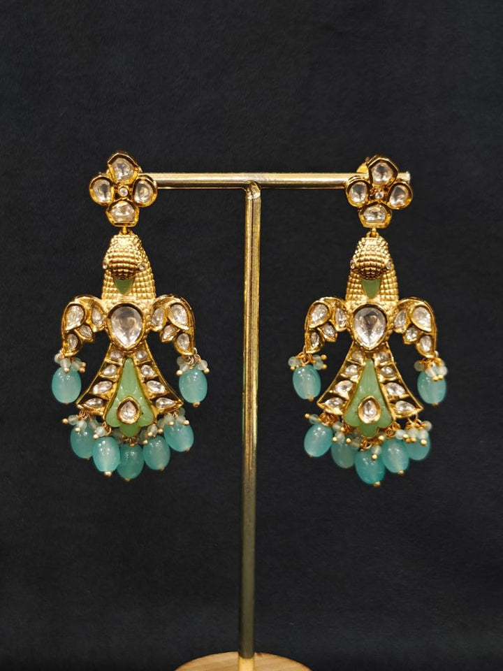 Close-up of an ornate traditional (Gold Polish) Sea Green Long jewellery set and earrings with Polki and Tumble Beads. Festive celebration look completed with premium imitation Polki jewelry. Woman wearing trending Polki artificial jewelry for the wedding season in India.