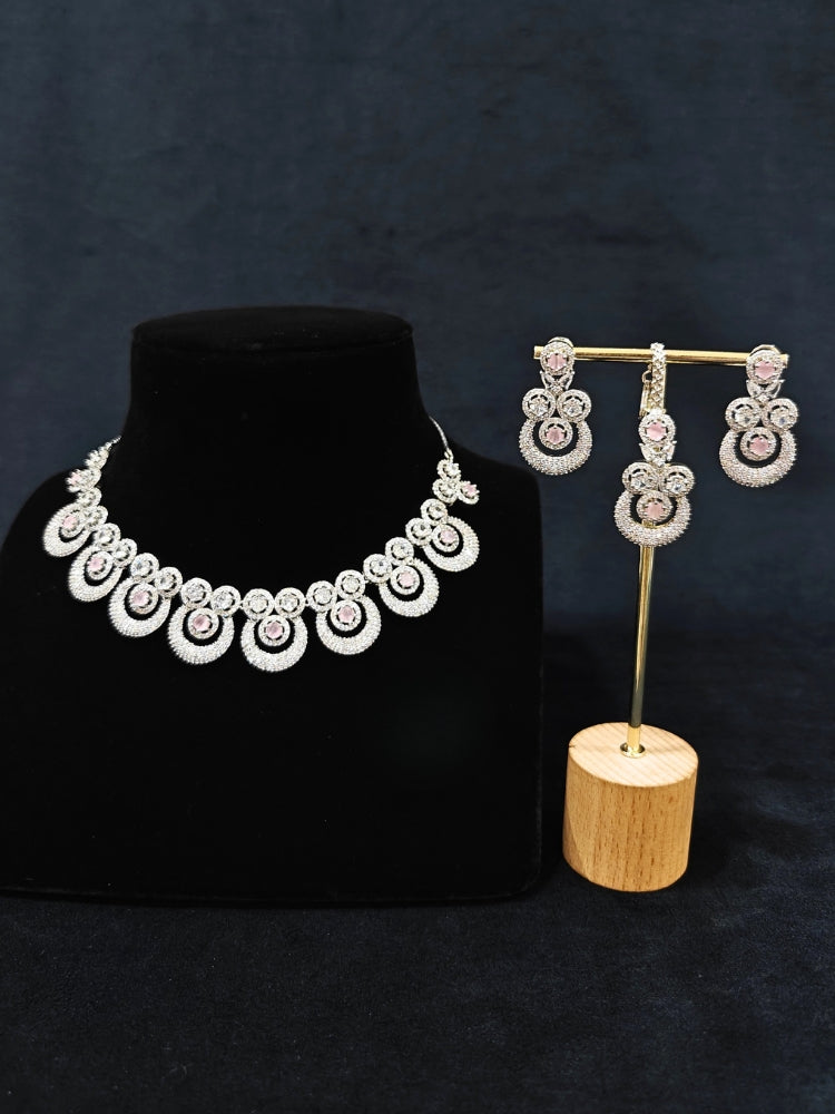 Close-up of an ornate Western Mint Pink Diamond SIlver Collar jewellery set and earrings and maangtikka with American Diamond and Mint Pink Colored Stones. A premium American diamond artificial necklace for her reception party. Close-up of a bridal look featuring an anti-tarnish American diamond artificial necklace.