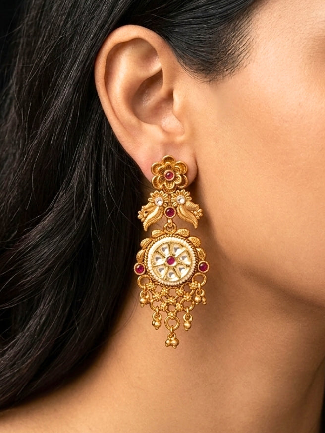 Close-up of a women wearing an ornate traditional (gold Polish) Choker jewellery set and earrings and maangtikka with Polki, Pink Colored Stone. A luxury artificial jewelry set styled for an Indian wedding celebration. Bride showcasing a premium imitation jewelry set for her reception look.