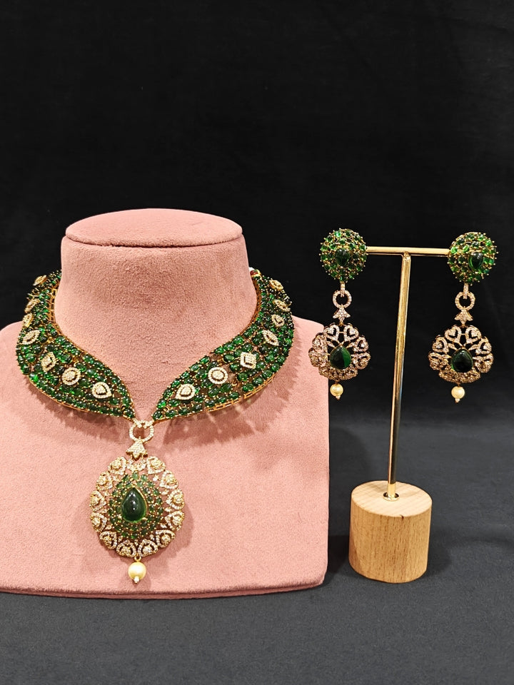 A luxurious artificial diamond jewelry featuring a designer diamond necklace, pota stone and green colored stone and earrings set, crafted for bridal fashion and high-end weddings. This beautiful diamond jewelry set offers the brilliance of real diamonds at an affordable price.