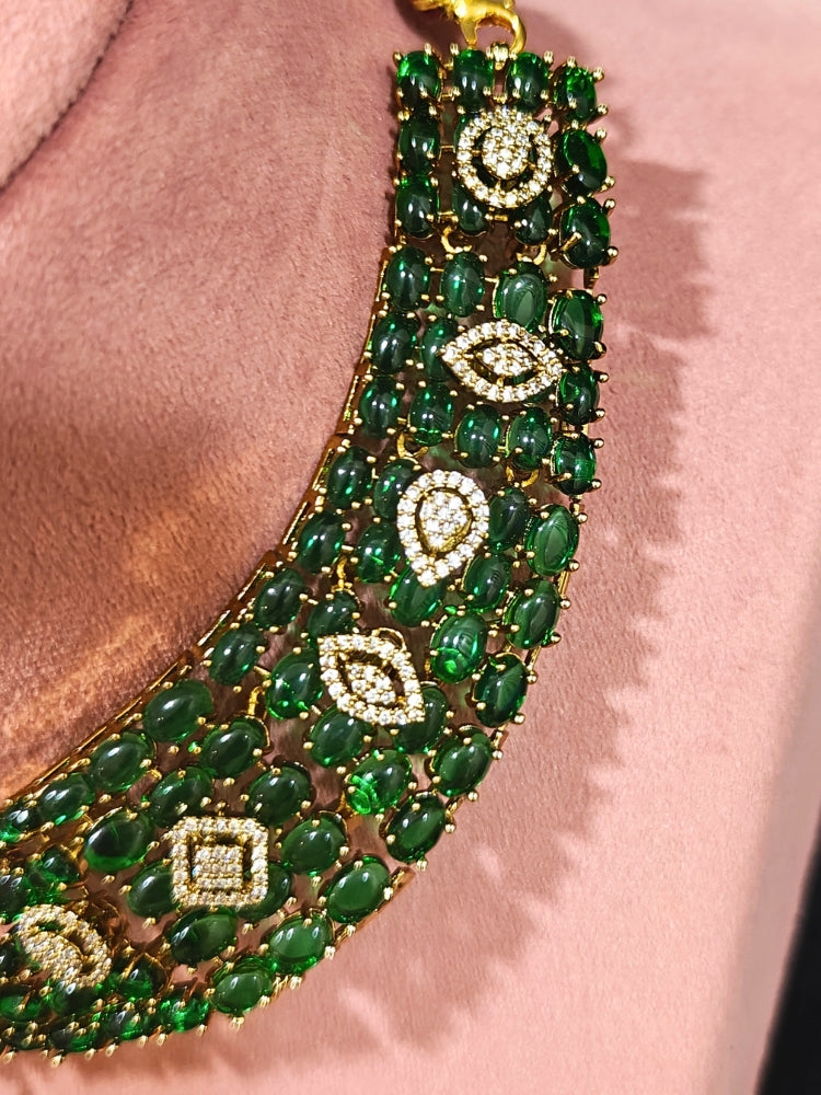 A luxurious artificial diamond jewelry featuring a designer diamond necklace, pota stone and green colored stone and earrings set, crafted for bridal fashion and high-end weddings. This beautiful diamond jewelry set offers the brilliance of real diamonds at an affordable price.