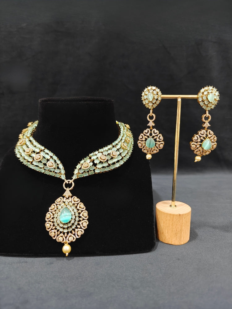 A sparkling artificial diamond, pota stone and mint green colored stone necklace and diamond earrings set, designed to offer a radiant, elegant look for any formal occasion or Indian wedding. This affordable diamond jewelry provides a flawless, luxurious alternative to natural diamonds.