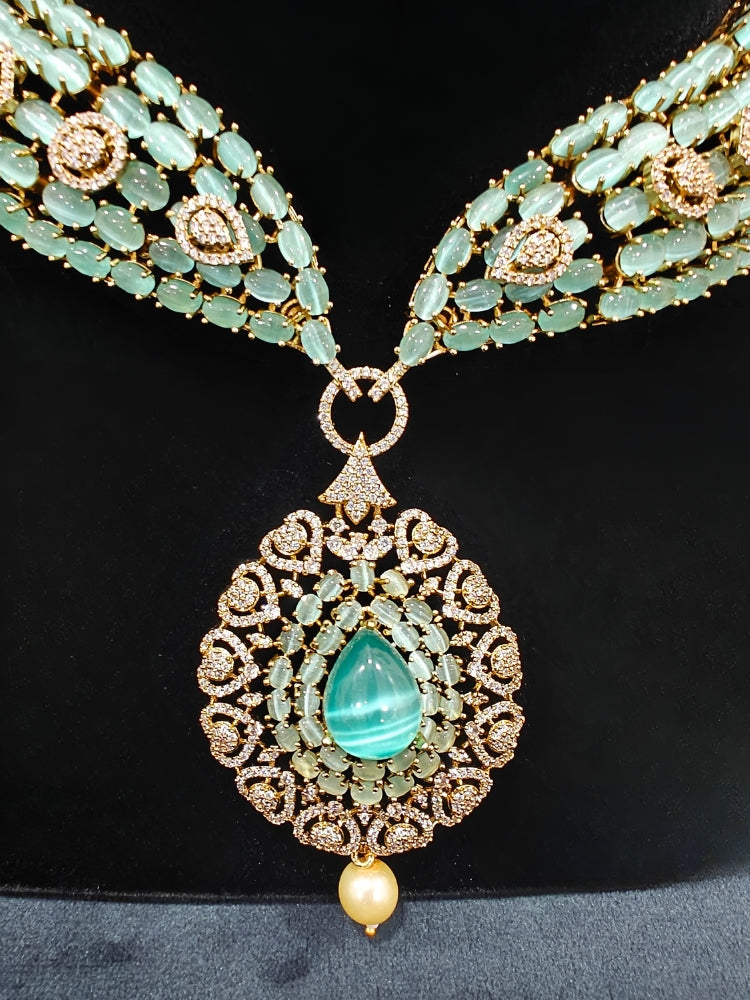 A sparkling artificial diamond, pota stone and mint green colored stone necklace and diamond earrings set, designed to offer a radiant, elegant look for any formal occasion or Indian wedding. This affordable diamond jewelry provides a flawless, luxurious alternative to natural diamonds.