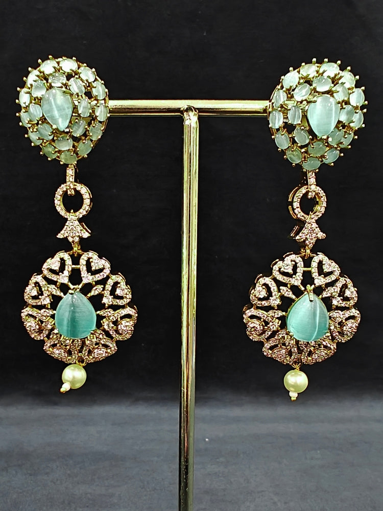 A sparkling artificial diamond, pota stone and mint green colored stone necklace and diamond earrings set, designed to offer a radiant, elegant look for any formal occasion or Indian wedding. This affordable diamond jewelry provides a flawless, luxurious alternative to natural diamonds.