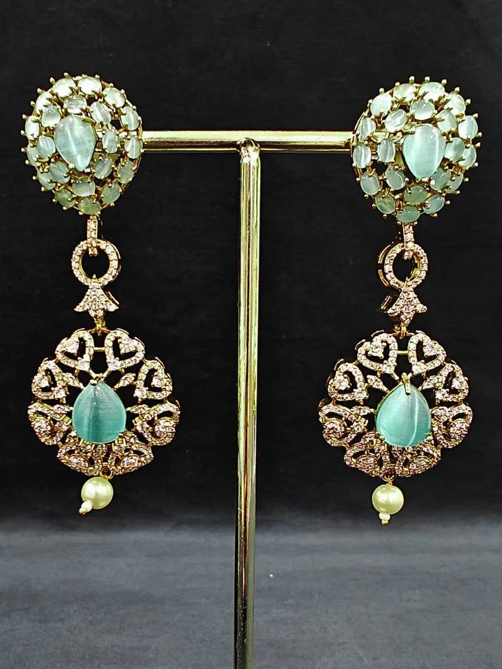 A sparkling artificial diamond, pota stone and mint green colored stone necklace and diamond earrings set, designed to offer a radiant, elegant look for any formal occasion or Indian wedding. This affordable diamond jewelry provides a flawless, luxurious alternative to natural diamonds.