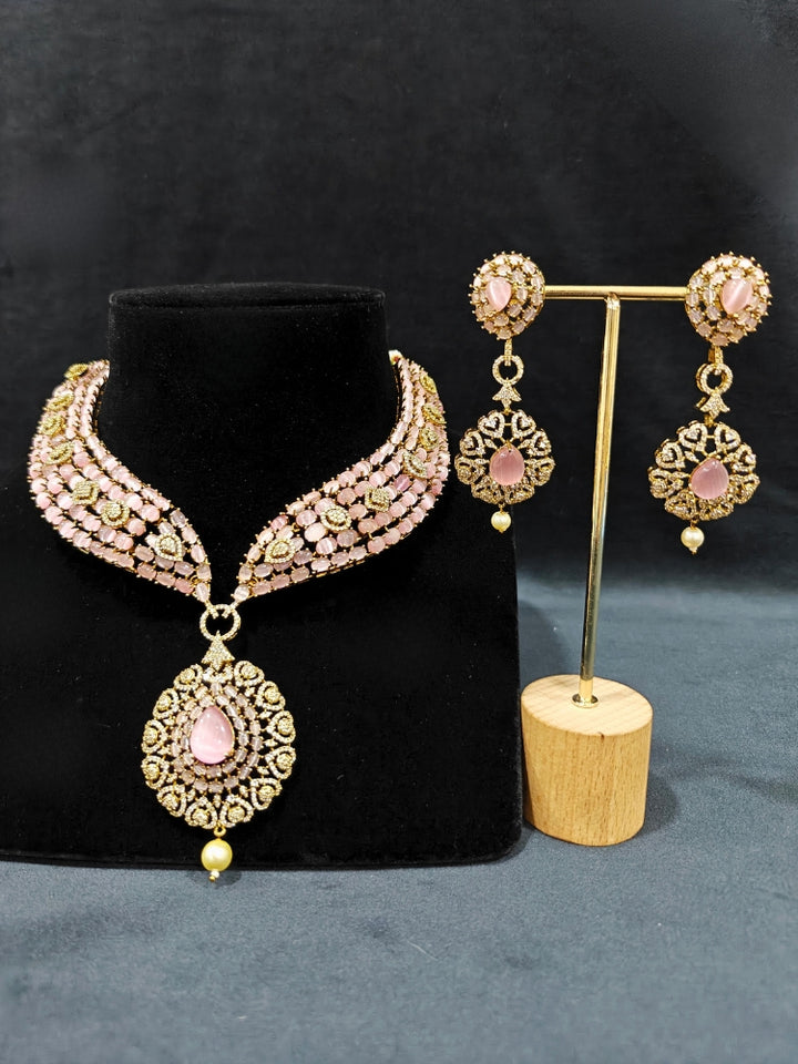 An exquisite artificial diamond, pota stone and mint pink colored stone necklace and matching earrings, designed for the perfect engagement look. This stunning artificial diamond jewelry set offers luxury and sophistication while being an affordable alternative to natural diamonds.