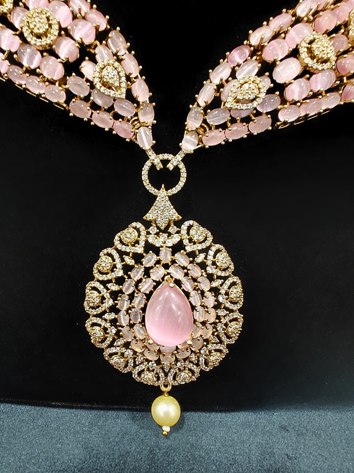 An exquisite artificial diamond, pota stone and mint pink colored stone necklace and matching earrings, designed for the perfect engagement look. This stunning artificial diamond jewelry set offers luxury and sophistication while being an affordable alternative to natural diamonds.