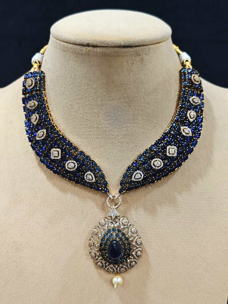 An exquisite artificial diamond, pota stone and navy blue colored stone necklace and matching earrings, designed for the perfect engagement look. This stunning artificial diamond jewelry set offers luxury and sophistication while being an affordable alternative to natural diamonds.