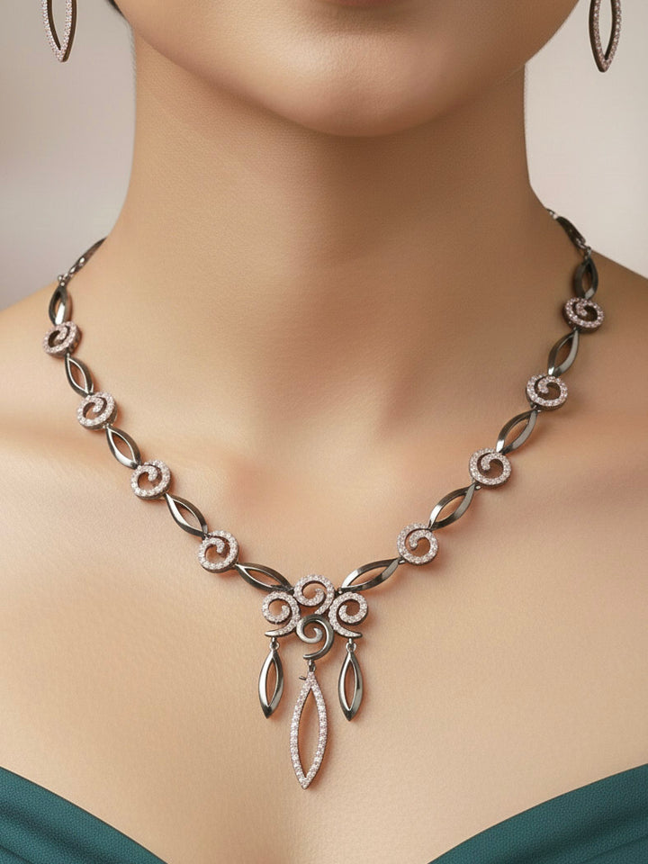 Close-up of a woman wearing an ornate Western Black & Pink (Black polish Victorian Finish) Collar jewellery set and earrings with American Diamond. Close-up of a cocktail party look featuring a premium American diamond necklace. Reception-ready look featuring a statement American diamond jewelry set.