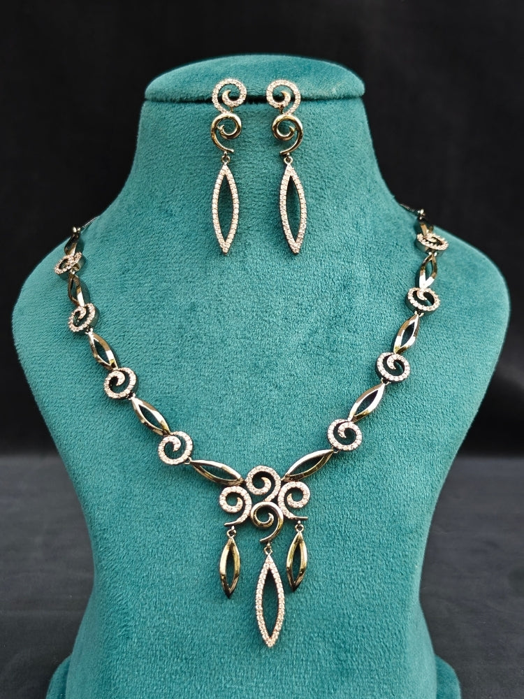 Close-up of an ornate Western Black & Pink (Black polish Victorian Finish) Collar jewellery set and earrings with American Diamond. Close-up of a cocktail party look featuring a premium American diamond necklace. Reception-ready look featuring a statement American diamond jewelry set.