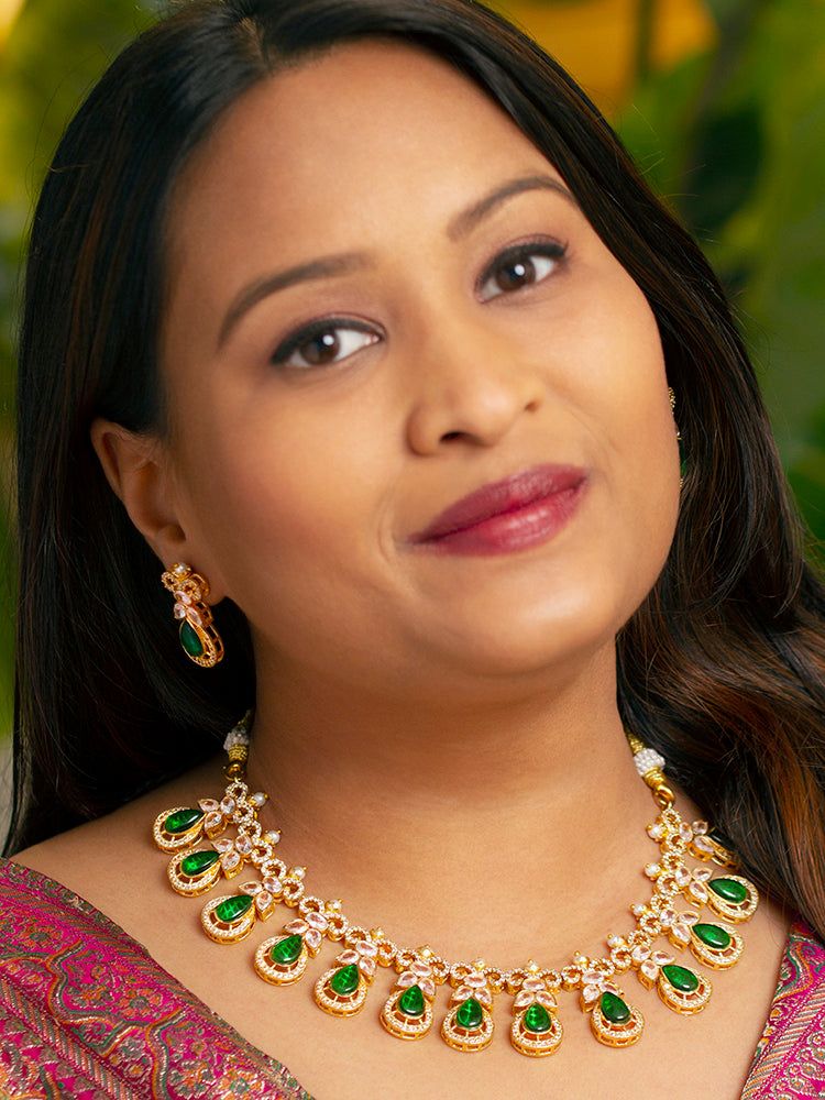 Close-up of a woman wearing a sparkling artificial diamond necklace with green colored stone and diamond earrings set, designed to offer a radiant, elegant look for any formal occasion or Indian wedding. This affordable diamond jewelry provides a flawless, luxurious alternative to natural diamonds.