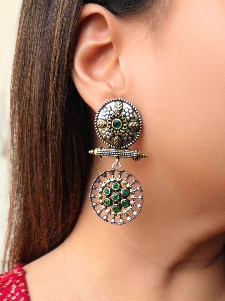 Close-up of a woman wearing an ornate traditional (Dual Tone Polish) Green Oxidised Earrings set with Kundan. Festive celebration look enhanced with sparkling artificial Oxidised Earrings. Saree look completed with elegant artificial Earrings set for festive occasions.