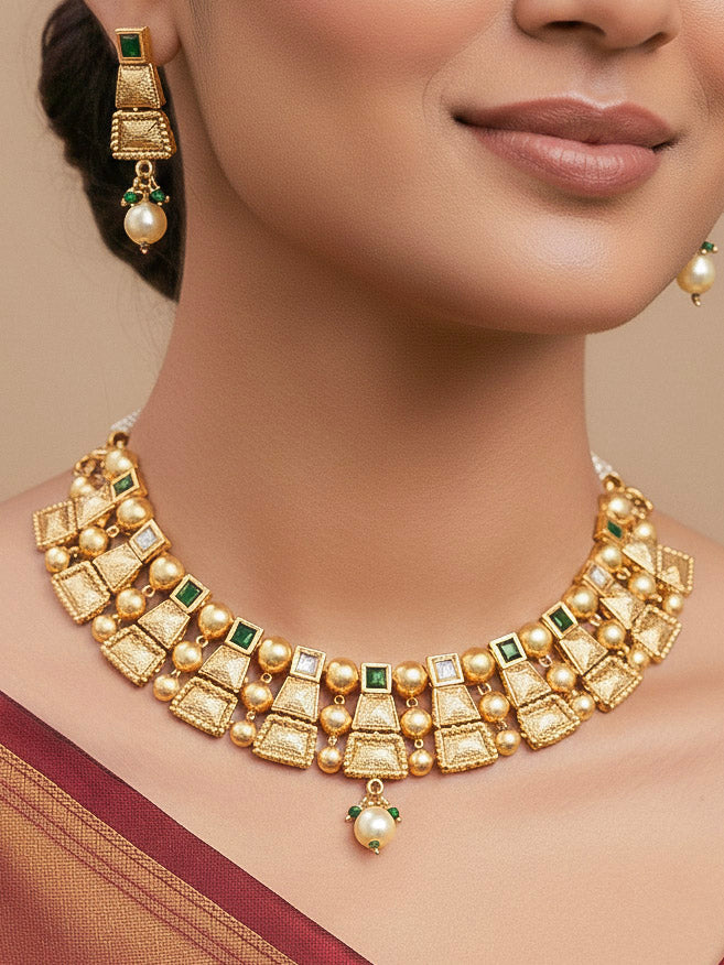 Close-up of a woman wearing an ornate traditional Green Rajwadi gold Collar jewellery set and earrings  with  Colored Stone and Kundan. Festive Diwali outfit enhanced with a Rajwadi artificial necklace. Close-up of a premium Rajwadi artificial necklace under 10000.