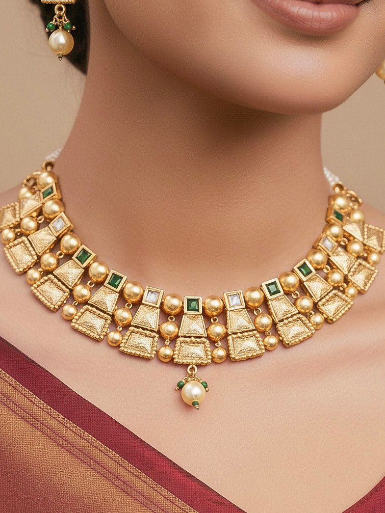 Close-up of a woman wearing an ornate traditional Green Rajwadi gold Collar jewellery set and earrings  with  Colored Stone and Kundan. Festive Diwali outfit enhanced with a Rajwadi artificial necklace. Close-up of a premium Rajwadi artificial necklace under 10000.