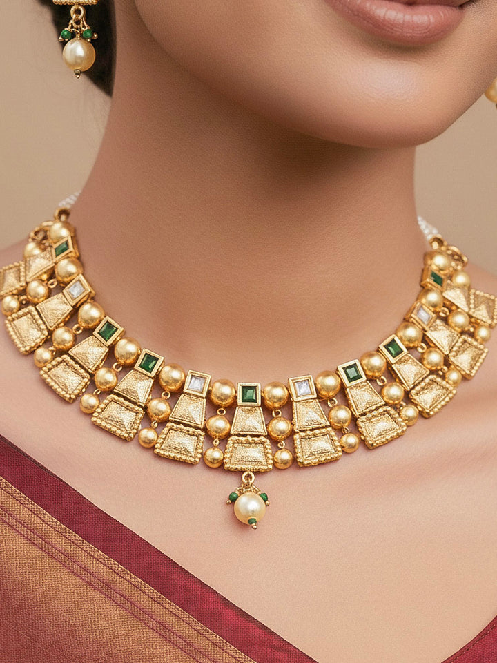 Close-up of a woman wearing an ornate traditional Green Rajwadi gold Collar jewellery set and earrings  with  Colored Stone and Kundan. Festive Diwali outfit enhanced with a Rajwadi artificial necklace. Close-up of a premium Rajwadi artificial necklace under 10000.