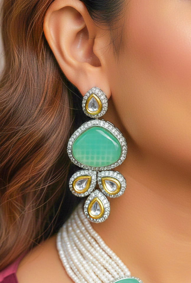Close-up of a woman wearing an ornate traditional Green Collar Kundan jewellery set and earrings with American diamonds, Monalisa stone, Pearls, Kundan and Colored Stones. Festive Diwali outfit paired with a premium Kundan jewelry piece. Woman wearing trending Kundan artificial jewelry for wedding season in India.