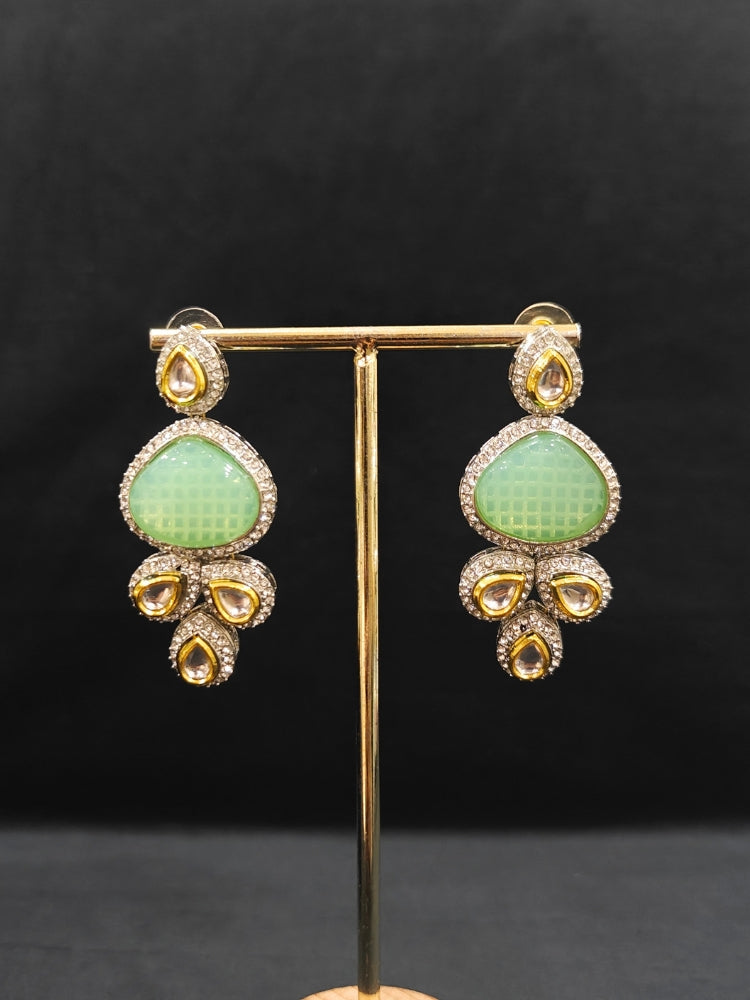 Close-up of an ornate traditional Green Collar Kundan jewellery set and earrings with American diamonds, Monalisa stone, Pearls, Kundan and Colored Stones. Festive Diwali outfit paired with a premium Kundan jewelry piece. A trending Kundan artificial jewelry for wedding season in India.