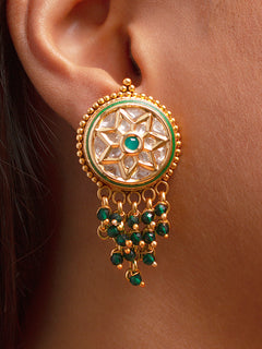 Close-up of a woman wearing an ornate Traditional (Gold Polish) Green Diamond Earrings with American Diamond and Crystal Beads. Festive Diwali look styled with premium artificial American Diamond earrings. Festive saree look completed with premium imitation American Diamond earrings.