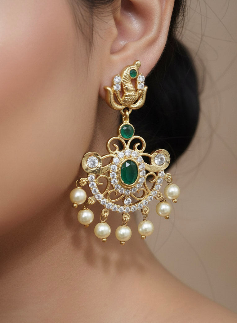 Close-up of a woman wearing an ornate traditional Green (gold Polish) Diamond jewellery set and earrings with American Diamond, Emerald Green Colored Stones and Pearls. A woman wearing a luxury American diamond necklace set styled beautifully for a wedding guest look in India. Model wearing a lightweight American diamond necklace perfect for long wedding functions.