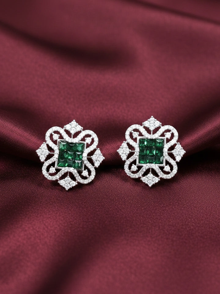 Close-up of an ornate Western (Silver Polish) Dark Green Diamond Studs Earrings with American Diamond. western dress styled with lightweight artificial American Diamond studs earrings. Wear in office and everyday.