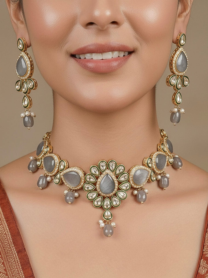 Close-up of a woman wearing an ornate traditional Grey Choker jewellery set and earrings and maangtikka with Kundan, Monalisa Stone, American Diamonds, Beads and Reverse American Diamonds and tumble stones. A graceful woman wearing a trending Colored Stone necklace for a 2026 wedding celebration. Elegant wedding jewelry look featuring a premium artificial Colored Stone necklace.