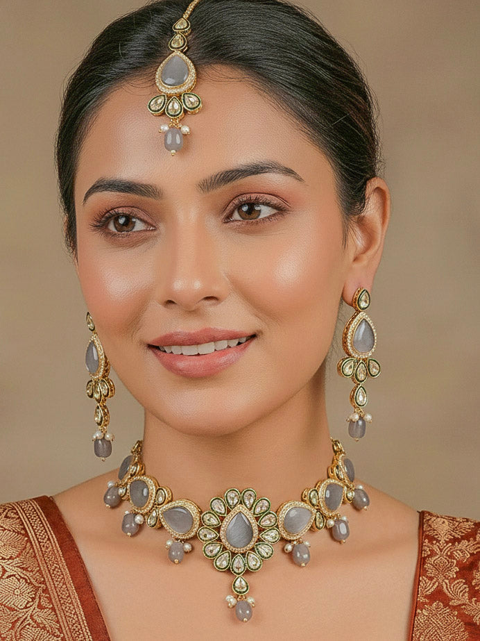 Close-up of a woman wearing an ornate traditional Grey Choker jewellery set and earrings and maangtikka with Kundan, Monalisa Stone, American Diamonds, Beads and Reverse American Diamonds and tumble stones. A graceful woman wearing a trending Colored Stone necklace for a 2026 wedding celebration. Elegant wedding jewelry look featuring a premium artificial Colored Stone necklace.