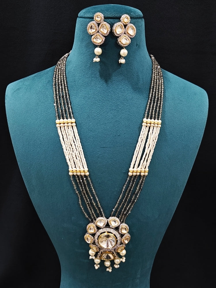 Close-up of an ornate traditional Grey Long jewellery set and earrings with Kundan, American Diamond, pearls and Crystal Beads. Mehendi ceremony look completed with a handcrafted Kundan jewelry set. Wedding guest wearing a lightweight Kundan necklace for a Wedding function.