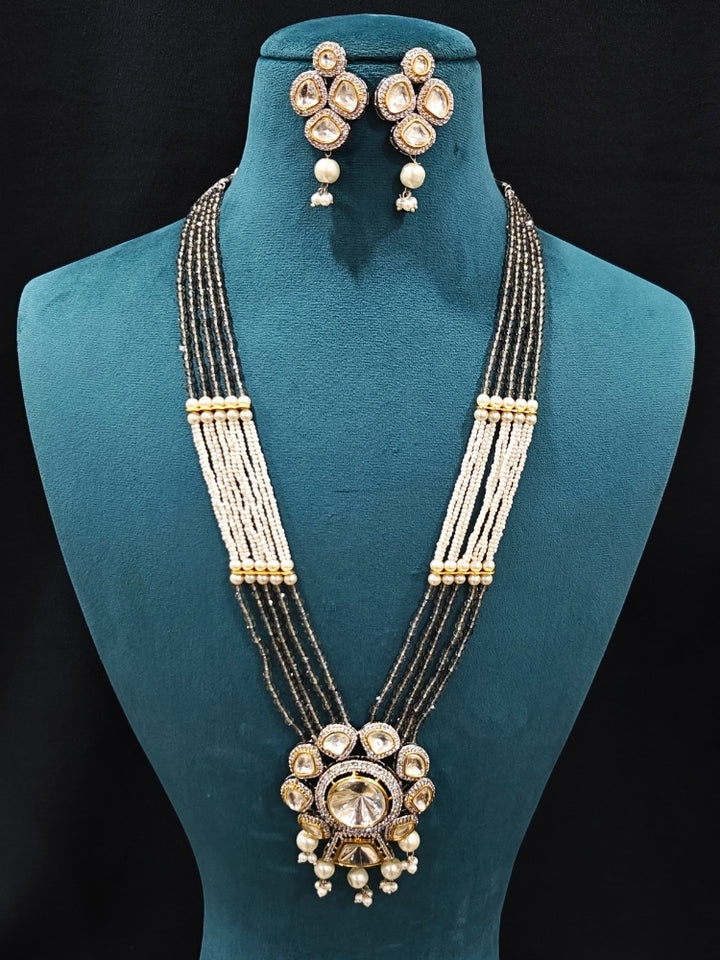 Close-up of an ornate traditional Grey Long jewellery set and earrings with Kundan, American Diamond, pearls and Crystal Beads. Mehendi ceremony look completed with a handcrafted Kundan jewelry set. Wedding guest wearing a lightweight Kundan necklace for a Wedding function.